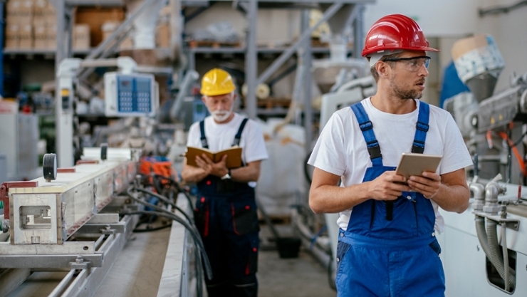 © iStock| Milos Dimic Two men monitor the work of a machine